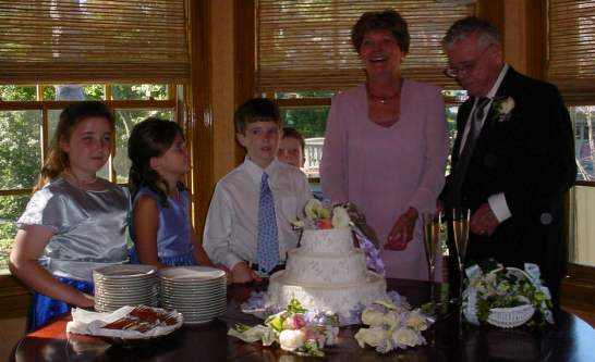 Dad and Evelyn pose with the flower girls and ring bearers before cutting the cake.