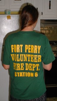 Teresa stands so you can read the FOR PERRY VOLUNTEER FIRE DEPARTMENT on her shirt.