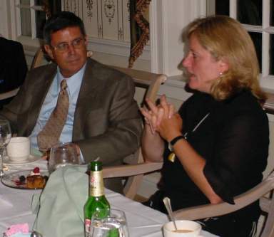 John and Elizabeth sit and talk while eating desert.