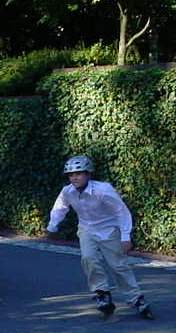 A rollerblader with a helmet on cruises through the scene.