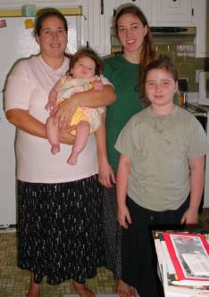 Tonia and her daughters pose quickly in Dad's kitchen.