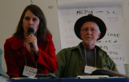 Erika with mike to the left of Tom in black hat.