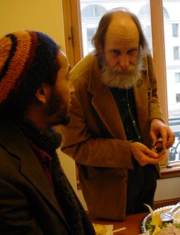 Two guys talking over food.