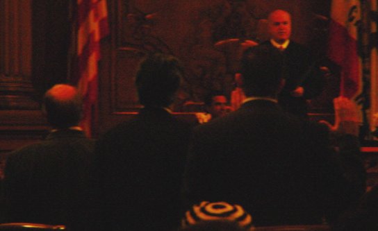 Candidates stand with right hand raised while Judge leads them in the Oath of Office.