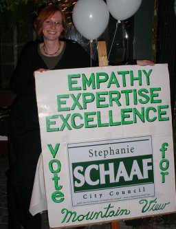 A picture of Stephanie Schaaf with her lawn sign and some Fred Art.