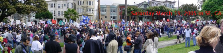 Lots of people with banners, signs, and whatnot having a good time in the street at Delores Park in San Francisco.