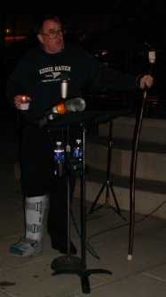 Guy with foot in cast at microphone.