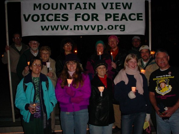 Everybody stands together in front of the MVVP Banner.