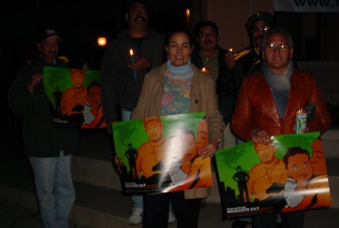 Latinos with IMMIGRANT DAY signs.