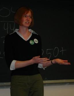 Stephanie speaking, with a hand gesture to her left.