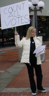 Blonde woman with a Count All Votes sign.