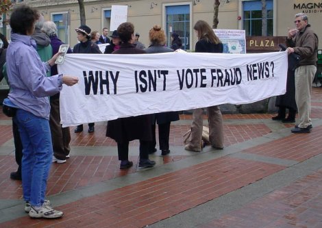 People holding a banner that reads "WHY ISN'T VOTE FRAUD NEWS?"