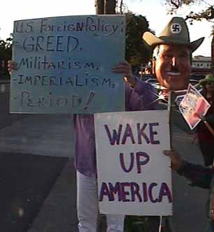 Offscreen person hold a sign that says WAKE UP AMERICA