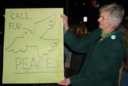 Woman holding a sign that says CALL FOR PEACE!