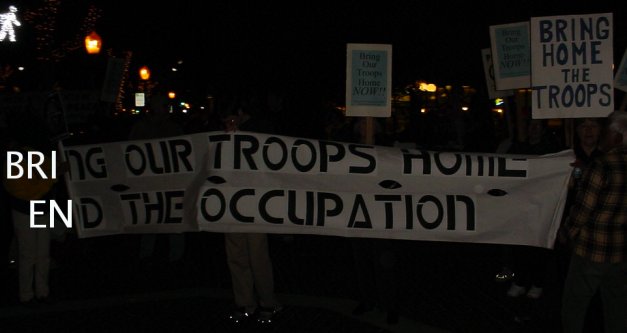 Huge banner. The top line says END THE OCUPATION, and the bottom line says BRING OUR TROOPS HOME.