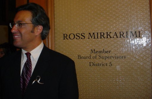Ross Stands by the door of his new office in San Francisco City Hall.