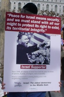 A picture of an Isreal supporter supporting a sign with a picture of MLK Jr. with the caption "Isreal Supporter".