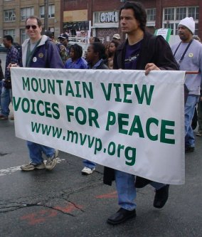 Mountain View Voices For Peace march with their banner.