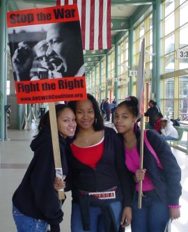 Three young women with a sign that says "STOP THE WAR!"