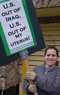 Woman with a sign that says "US OUT OF MY UTERUS".