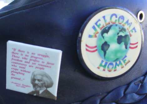 Two buttons. One says "Expecting progress without struggle is like expecting crops without plowing the ground". The other is a picture of mother earth, with the slogan "wecome home".