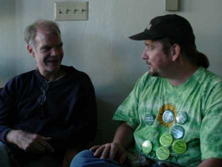 Two guzs sit and talk about something.