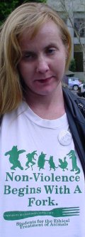 Woman with bored look in a shirt that says "go vegan".