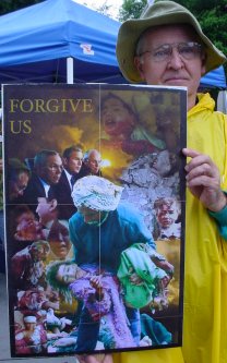 The sign says "Forgive US", with haunting pictures of bad things.