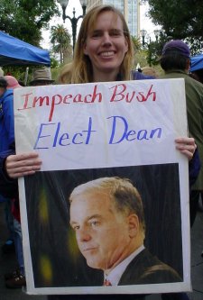 Blonde with a sign that says "IMPEACH BUSH ELECT DEAN"