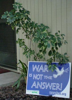 Plants by door support a WAR IS NOT THE ANSWER sign with a MEND YOUR FUELISH WAYS in the lower left corner.