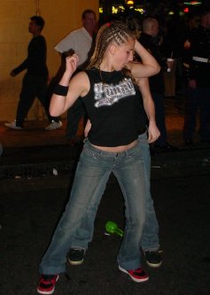 Two women bump in the street.