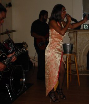 Singer leans into a long note while making a gesture.
