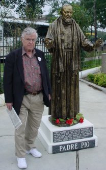 Dad stands with a statue.
