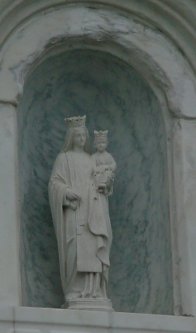 Figurine in an alcove holding a baby.